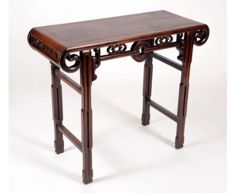 A Chinese hardwood altar or scholar's table, of small proportions, rectangular top with scroll ends, above a shaped frieze pi