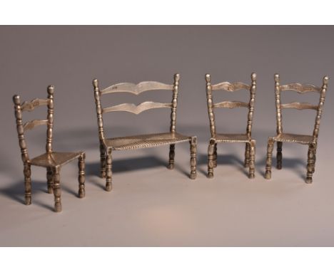 A Continental silver toy novelty miniature four piece suite, in the 19th century vernacular taste, faux rush seats, the sofa 