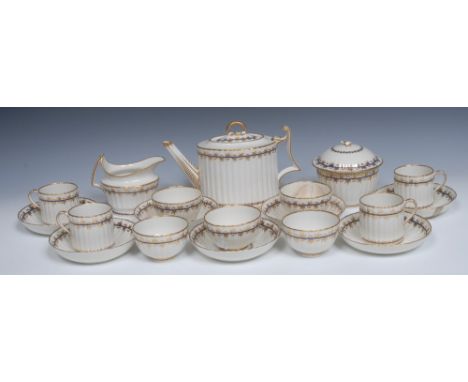 A Derby tea service,  comprising fluted teapot and stand, sucrier and cover, milk jug, seven tea saucers,  five tea bowls and