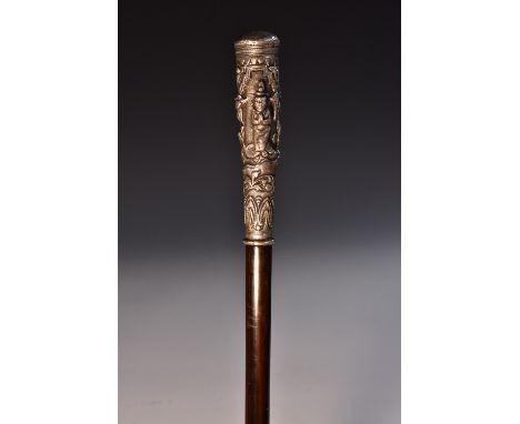 A late 19th century Indo-Tibetan white metal and hardwood walking stick, the long pommel cast in alternating tones of relief 