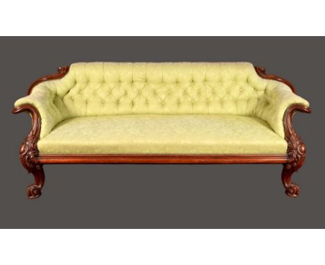 A substantial Victorian mahogany sofa, boldly carved with acanthus  scrolls, stuffed-over pale green damask upholstery, steel