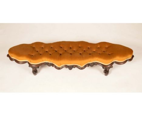 A Victorian mahogany sofa-length foot stool, stuffed-over deep button upholstery, cabriole legs, 108cm wide, c. 1850