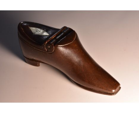 A 19th century novelty mahogany snuff box, as a shoe, incurved hinged cover, inset monogrammed lozenge, 11cm long c. 1840