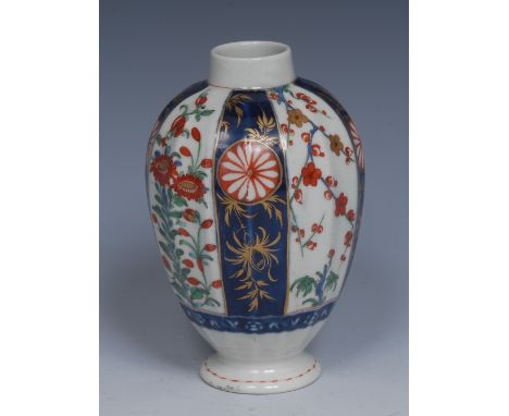 A Worcester Queens pattern facetted ovoid tea canister, decorated with alternating panels of mons, blossoming prunus and flow