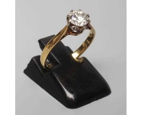 A SOLITAIRE DIAMOND RING, the brilliant cut stone of approximately 0.60cts, claw set to a plain shank stamped 18ct, size K (E