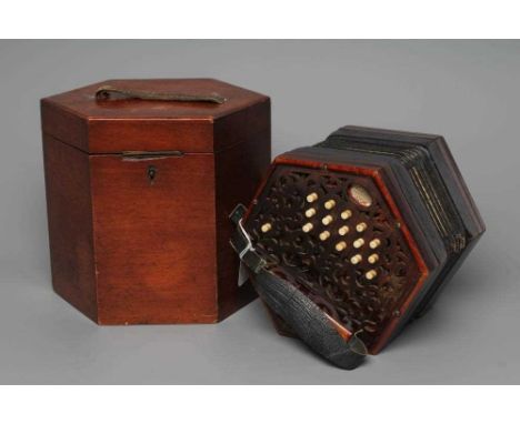 A LACHENAL &amp; CO. CONCERTINA of typical hexagonal form, with fret carved scroll design to both ends, paper label and thirt