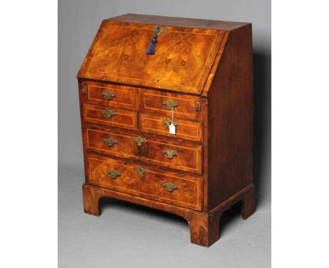 A GEORGIAN WALNUT BUREAU, third quarter 18th century, the banded fallfront with stringing enclosing interior with drawers and