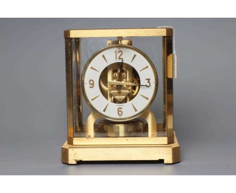 A JAEGER LECOULTRE ATMOS CLOCK, No 217094, the 4 3/4" white enamelled chapter ring with gilt Arabic and baton numerals, in gl