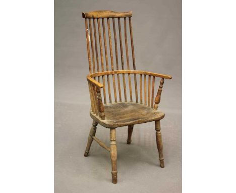 A COMB BACK WINDSOR ARMCHAIR, 18th century, (AF) in ash and elm, arched top rail, baluster turned arm supports, saddle seat, 