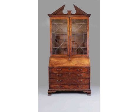 A GEORGIAN MAHOGANY BUREAU BOOKCASE, third quarter 18th century, the moulded cornice with broken pediment over two astragal g