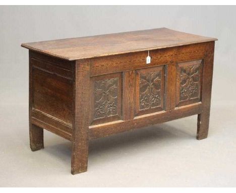 AN OAK PANELLED COFFER, early 18th century, the moulded edged plank lid opening to interior with shelf and small drawers, the