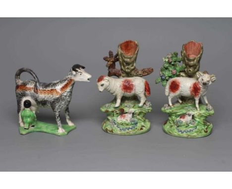 A PAIR OF WALTON EARTHENWARE SPILL VASES, early 19th century, modelled as a ram and ewe both standing on shredded clay encrus