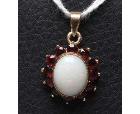 AN OPAL AND GARNET CLUSTER PENDANT, the oval cabochon polished opal collet set to a border of small facet cut garnets, Birmin