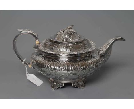 A GEORGE IV SILVER TEAPOT, maker's mark GH, London 1828, of squat globular form chased with a band of stiff leaves over two (