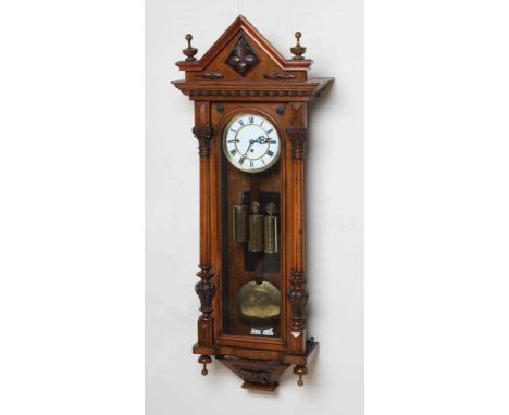 A WALNUT VIENNA TYPE WALL CLOCK, c.1890, the triple weight driven movement striking on gongs, 6 1/4" two piece white enamel d