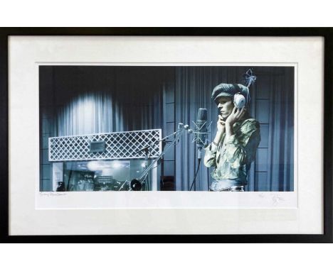 A well mounted, framed and glazed print of a photograph of David Bowie recording at the BBC circa early 1970s. Numbered 10/25