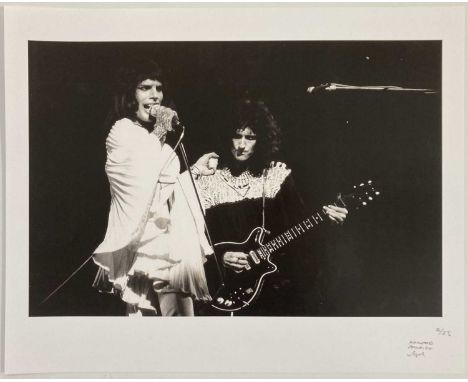 A limited-edition photo print from an edition of 25, 20 x 16". Depicts Queen onstage.