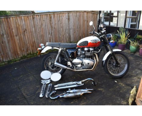 A 2007 Triumph Bonneville T100 scrambler, registration number WA07 AYS, white and red. This very low mileage (1,100 miles fro