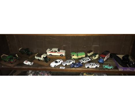 A shelf of diecast cars etc. and a Garmin Satnav