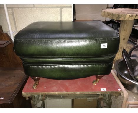 A green leather foot stool pouffe