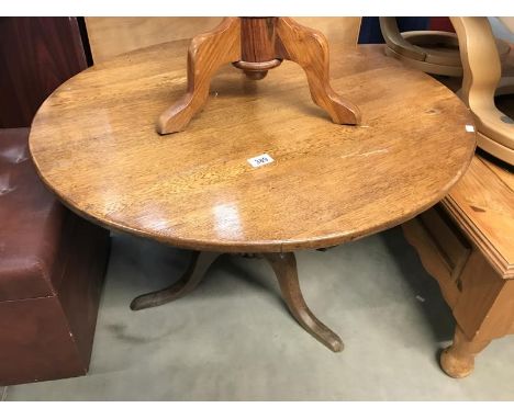 A solid oak tripod tea table