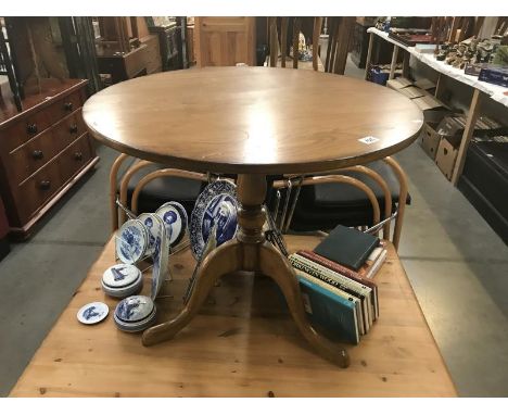 A solid oak tripod tea table