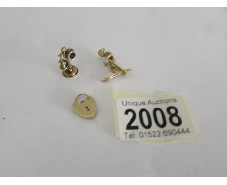 A 9ct gold padlock and 2 9ct gold charms being a candlestick telephone and a skier.  Approximately 8 grams. ****Condition rep