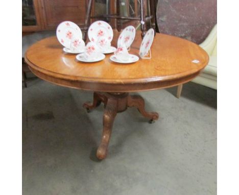 A pale mahogany tripod dining table.