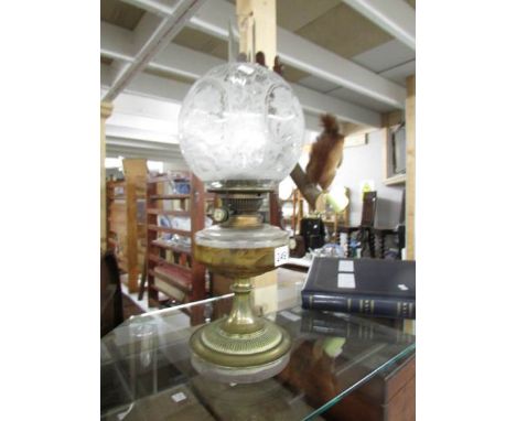 A Victorian oil lamp with original acid etched shade.