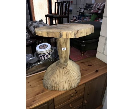 A carved tree trunk garden table