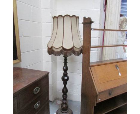 An old wooden standard lamp, shade a/f.