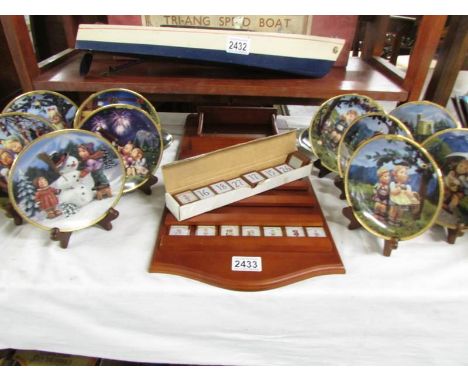 A vintage M J Hummel Seasons of Joy perpetual calendar, tiles, 12 plates and 11 stands.