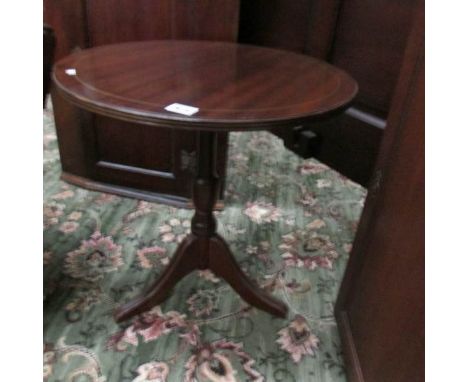 A 20th century mahogany tripod table.