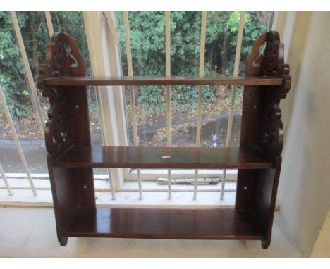 A mahogany fretwork open wall shelf unit 