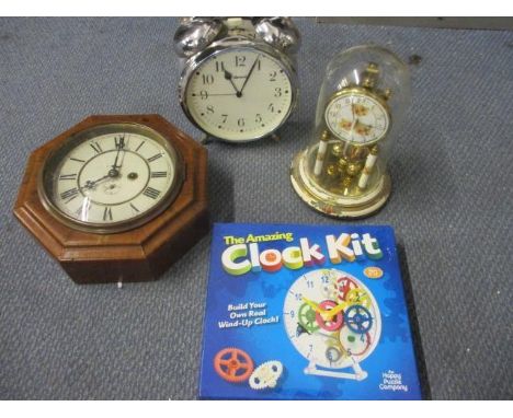 An over-sized Ingersol alarm clock, a walnut cased wall clock, an anniversary clock and a modern clock kit, boxed 