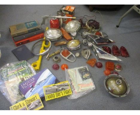 A pair of chrome Jaguar XK150 rear light fittings, mixed car parts, manuals and ephemera, a steering wheel lock, a spray pump