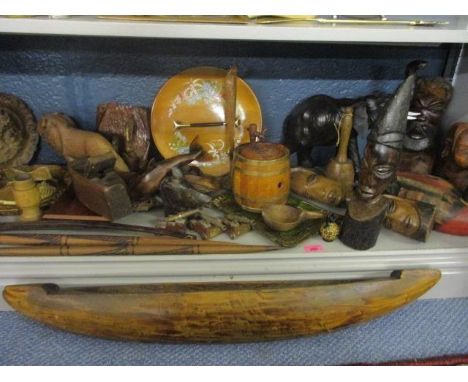 A quantity of African carved busts and models of animals, mixed treen and a small wooden hardwood canoe 