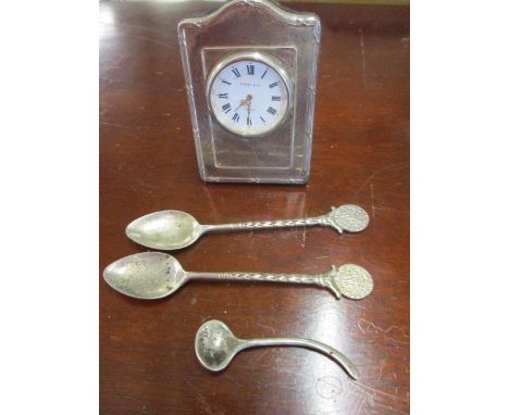 A Kitney and Co silver miniature clock and three silver spoons 
