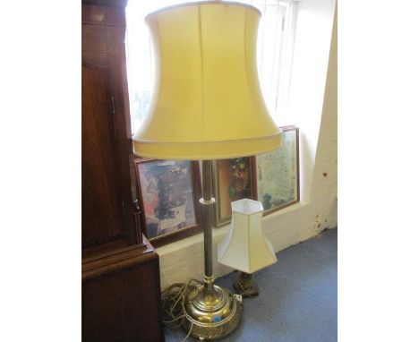 A mid 20th century brass standard lamp with shade, together with a brass table lamp and shade 