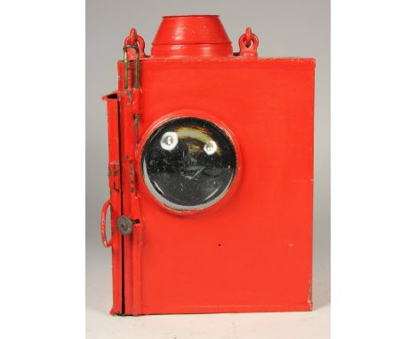 A large red unmarked signal lamp, complete with burner