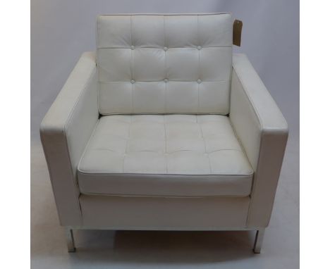 A white leather button back armchair
