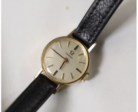 A lady's 1960's 9ct gold Omega manual wind wrist watch, on a leather strap with Omega buckle, the case back with inscription,
