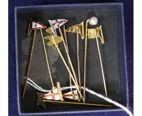 Five assorted 9ct and enamelled pennant stick pins, a yellow metal, a ruby and diamond set pennant stick and two others inclu