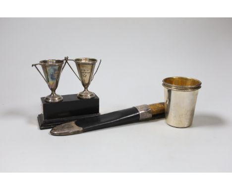 A pair of small silver beakers with gilt interiors and leaded rims, WW, London, 2000, 70mm, two small trophy cups on plinth a