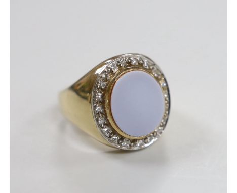 A modern 9ct gold and white carnelian set oval dress ring, with diamond chip set border, size R, gross weight 17.1 grams.