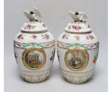 Two Dresden porcelain vases with bird decoration finials, and central horse scenes display, 30cm tall