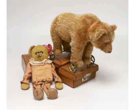 A Steiff bear on wheels, glass eyes, with original collar, no button, c.1920, height to shoulder 7in., good condition with sl