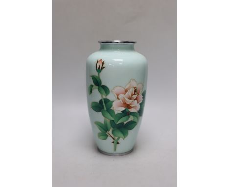 A Japanese cloisonné enamel vase decorated with roses upon a pale blue ground, silvered rim and base, 22cm high