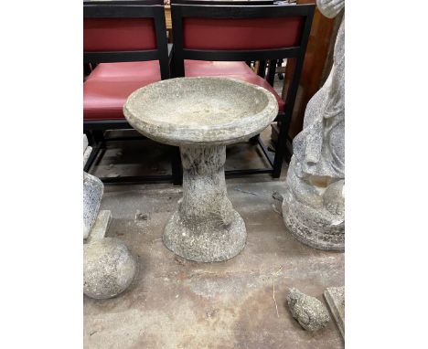 A circular reconstituted stone bird bath, on simulated trunk base, diameter 47cm, height 61cm
