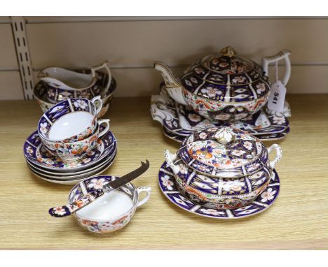 A mid 19th century Derby Imari pattern tea service, comprising a pair of two handled cake plates, a teapot on stand, a sucrie